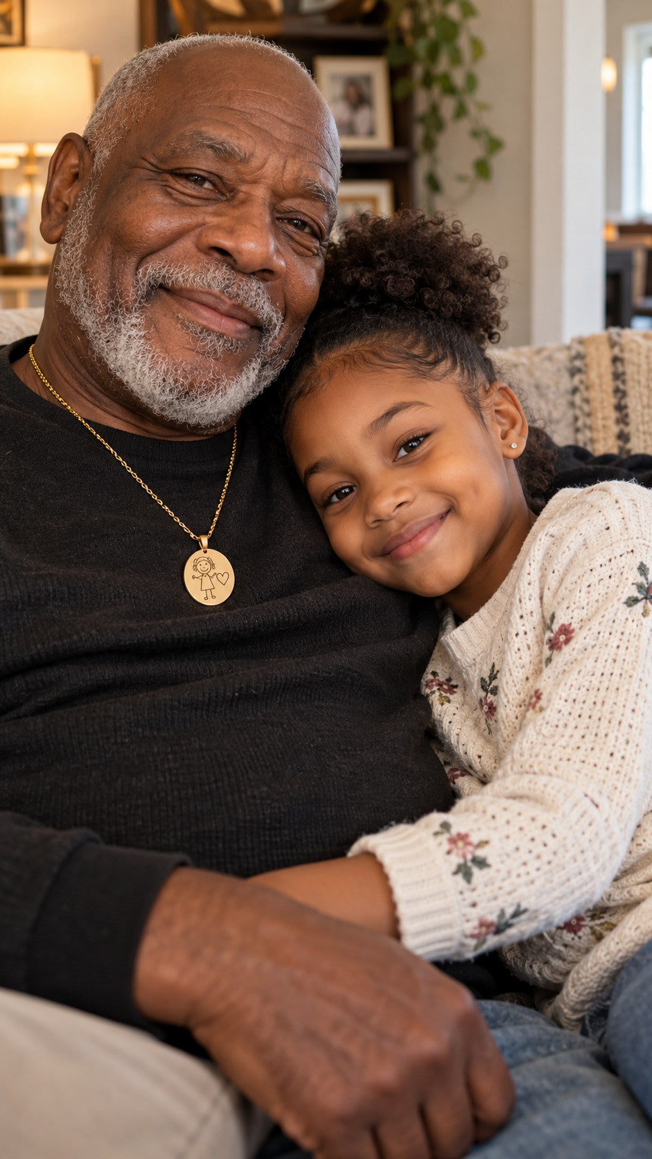 Grandfather and granddaughter cuddling together, grandfather wearing a keepsake drawing necklace
